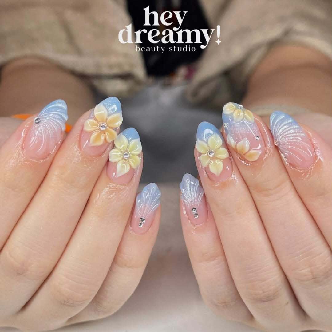 Pastel blue and pink nails with yellow flowers and pearl-like shimmer by Hey Dreamy
